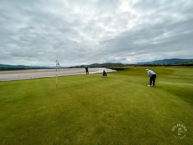 A wide view at Waterville, with the fairway, the bay, and the mountains.