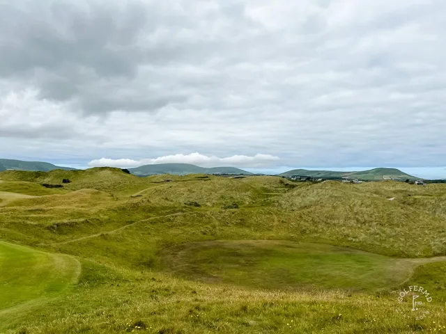 A green and flagstick at Waterville, a deep bunker short of the hole and the dunes behind.