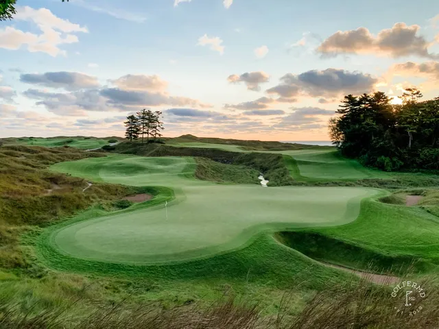 A wide view of the Straits Course, fescue and sand hills along the water.
