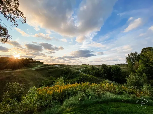 The shoreline and the links on the Straits Course under a cloudy sky.