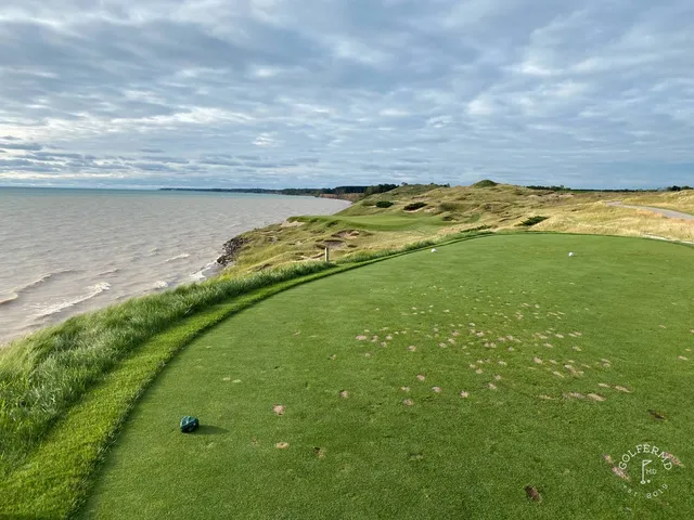 A close flagstick on the Straits Course, with the lake just beyond the green.