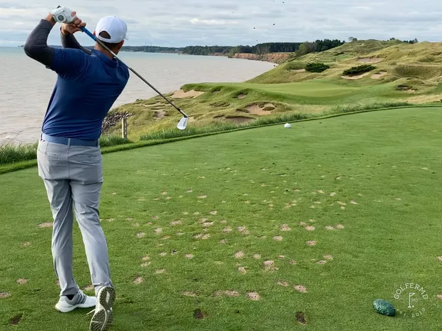 A green and bunker on the Straits Course, the flagstick against the lake.
