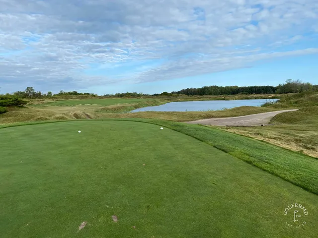 A carry across sand on the Straits Course, the fairway starting again beyond a waste area.