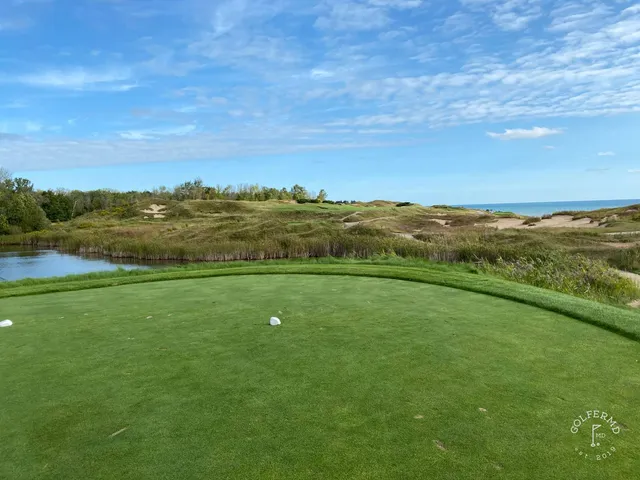 The lake along one side of a fairway on the Straits Course, with fescue on the other.