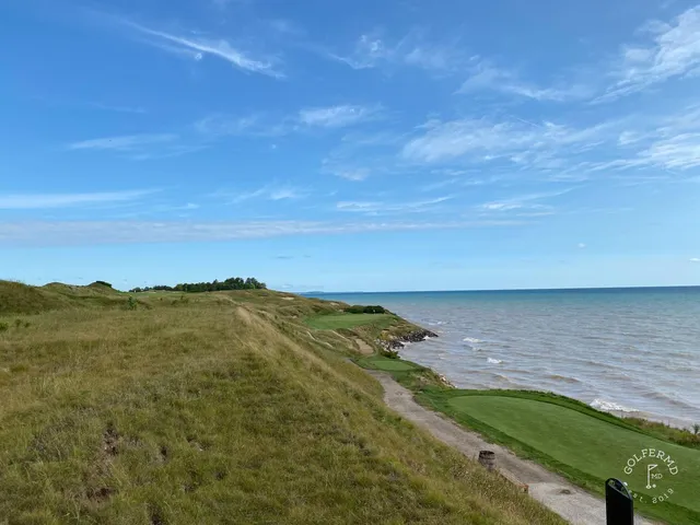 A tee on the Straits Course set in the dunes, the hole dropping toward the shore.