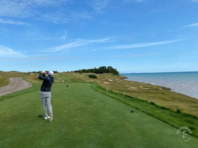 A long view down the shore from the Straits Course, holes strung along the dunes.