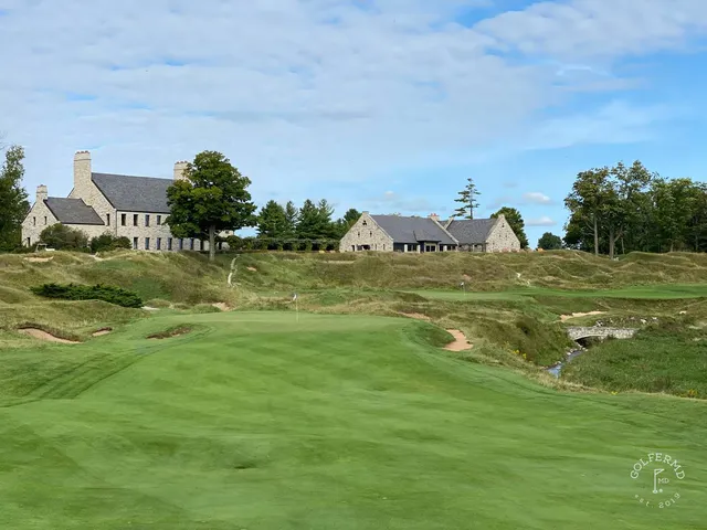 A green on the Straits Course with the pin toward the back and sand short of the hole.