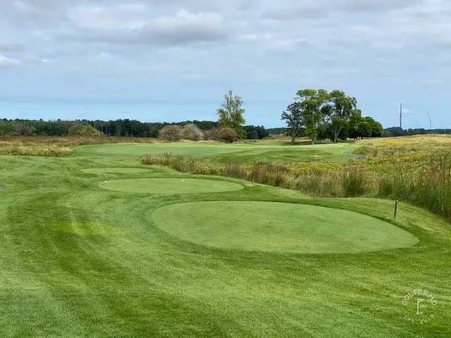 A last wide view of the Straits Course at Whistling Straits, the links spread along Lake Michigan.