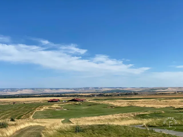 A panorama of the rolling hills at Wine Valley, with fairways and scattered trees under a cloudy sky.