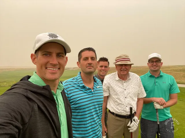 A green at Wine Valley with the flagstick, a bunker on the front left, and the fairway behind the hole.