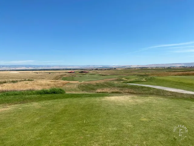 A green at Wine Valley, the flagstick standing over a bunker across the front and the fairway running back.