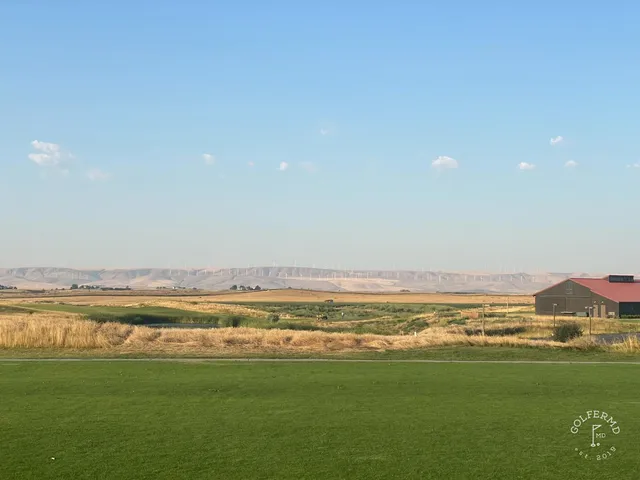 A wide fairway at Wine Valley, with a bunker on the left and the green set against the hills.