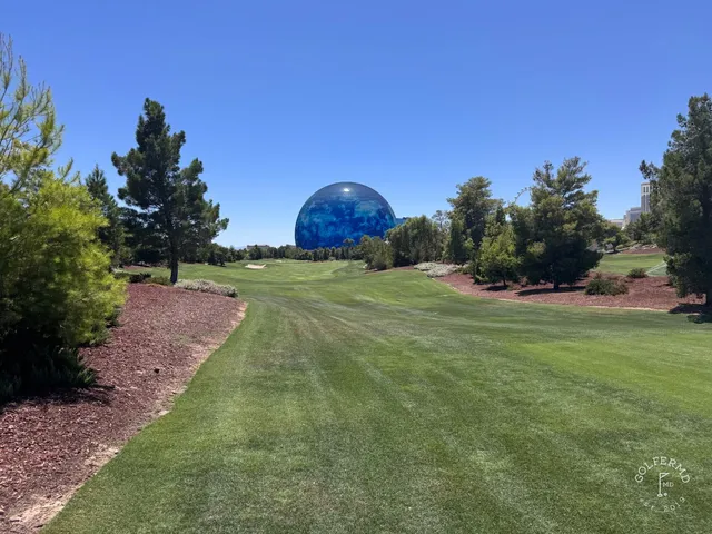 A wide fairway at Wynn Golf Club, with the Las Vegas Strip in the distance.